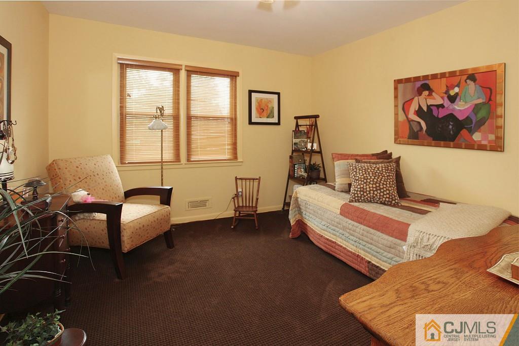 25 Clive Hills Road Edison, NJ 08820 - Photo 24 of 25 a spacious bedroom with a bed and couch