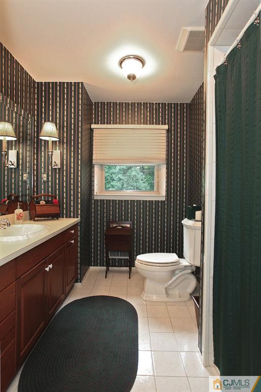 25 Clive Hills Road Edison, NJ 08820 - Photo 25 of 25 a spacious bathroom with a toilet sink and mirror