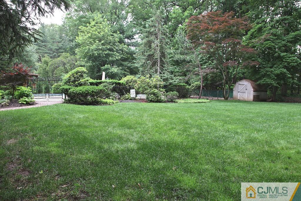 25 Clive Hills Road Edison, NJ 08820 - Photo 8 of 25 a view of a house with a big yard and large trees