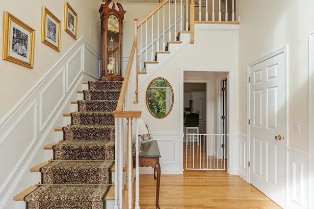 a view of a hallway with wooden floor and entryway