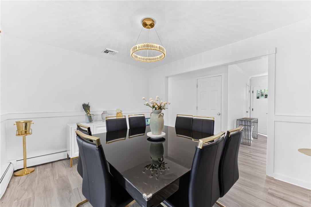 7290 Heather Road Macungie, PA 18062 - Photo 13 of 39 A refined dining space features a striking contemporary chandelier above sleek seating.