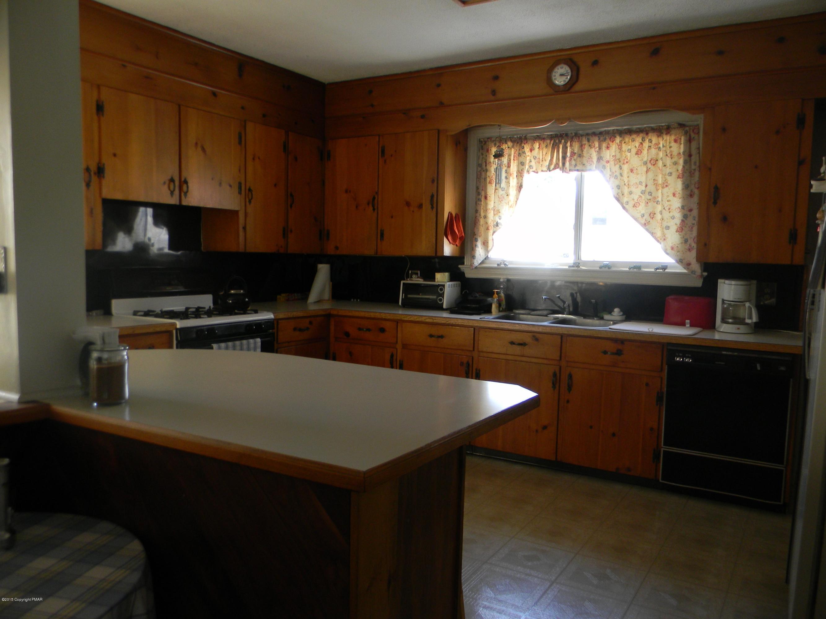 223 Tanite Road Stroudsburg, PA 18360 - Photo 3 of 8 a kitchen with a sink a window and cabinets