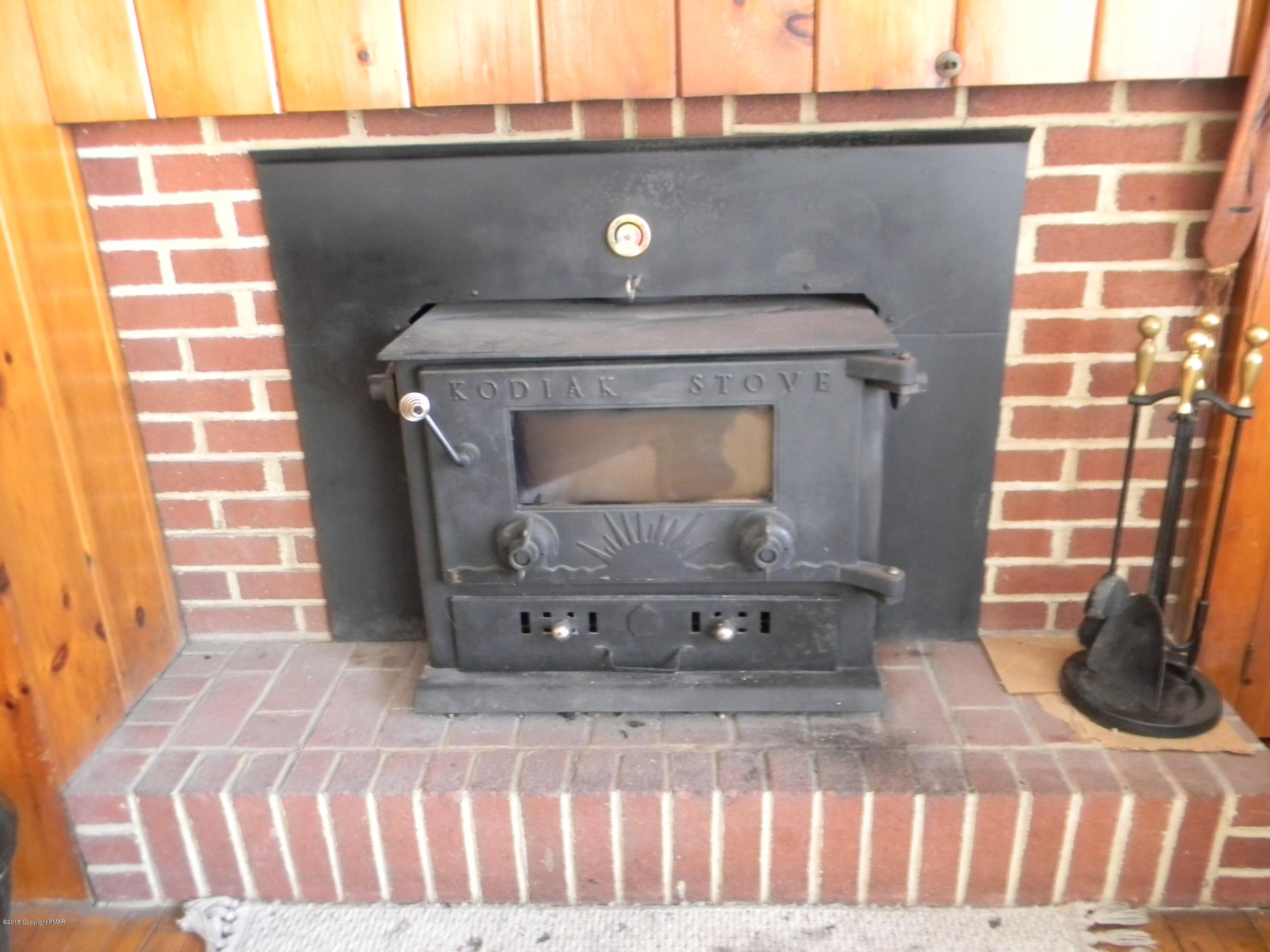 223 Tanite Road Stroudsburg, PA 18360 - Photo 4 of 8 a view of fireplace and a wooden floor