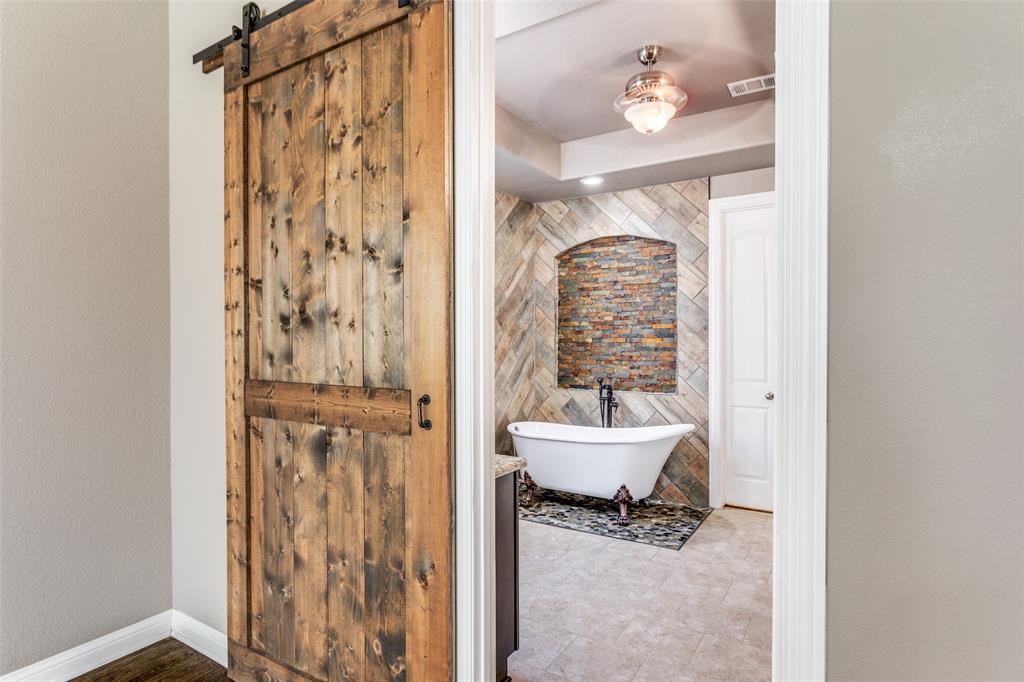 1505 5th Street Argyle, TX 76226 - Photo 15 of 25 a bathroom with a shower curtain and a sink