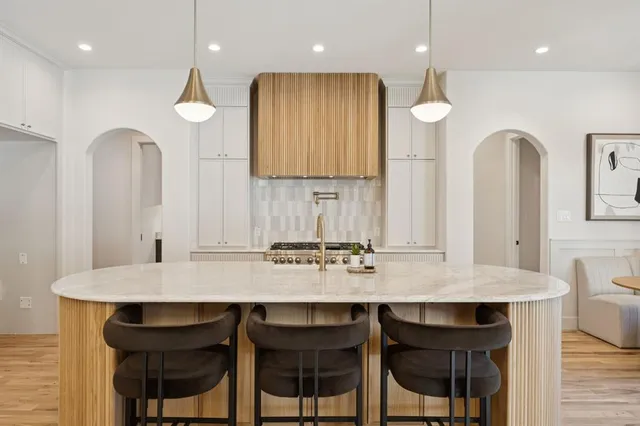 a kitchen with granite countertop a table and chairs in it