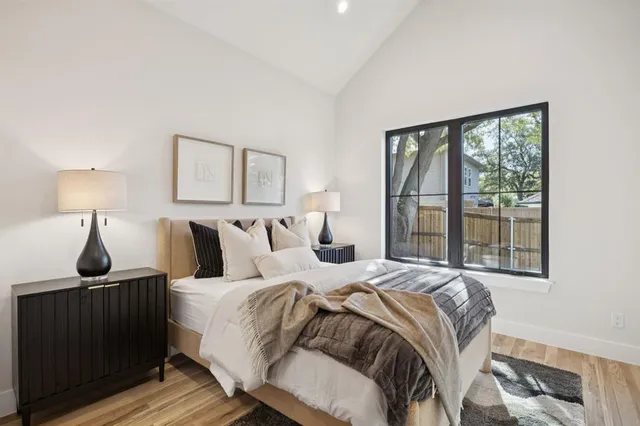 a bedroom with a bed and a window