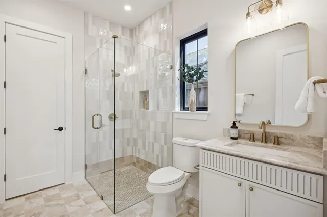 a bathroom with a sink toilet and shower