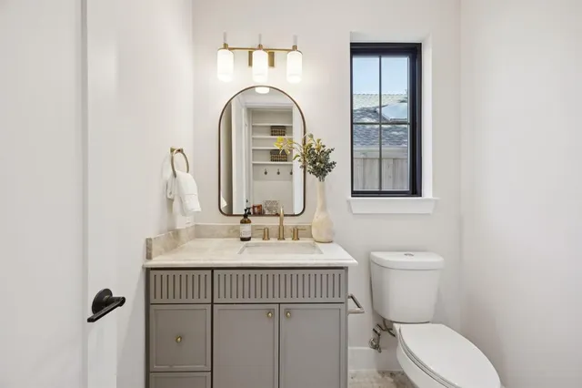 a bathroom with a toilet sink and mirror