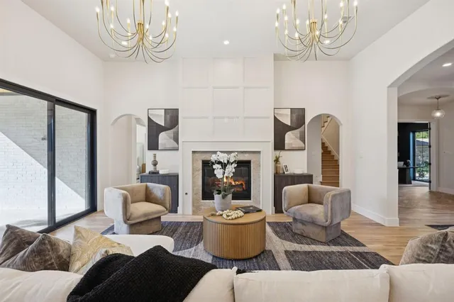a living room with furniture and a chandelier