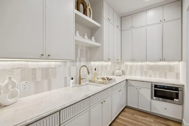 a kitchen with a sink and cabinets