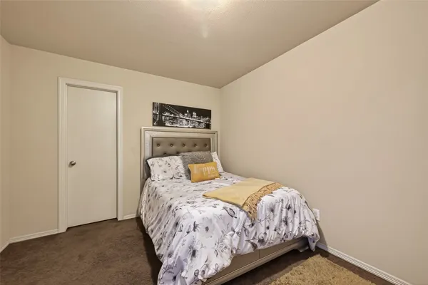 a view of a house with backyard and a tree