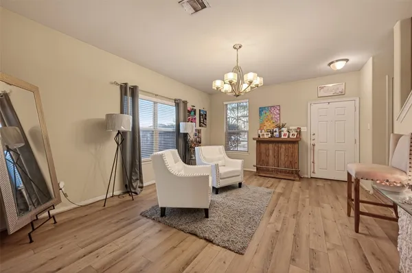 a living room with furniture and wooden floor