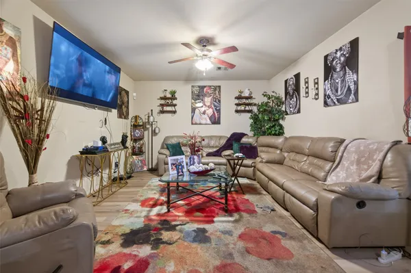 a living room with furniture a large window and a flat screen tv