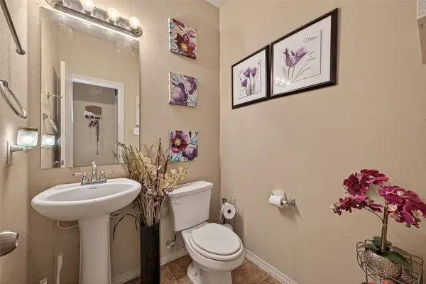 a view of backyard with large tree and wooden fence