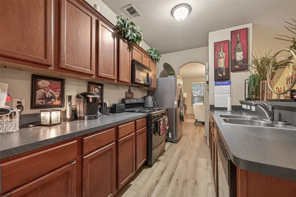 a view of a yard with large tree and wooden fence