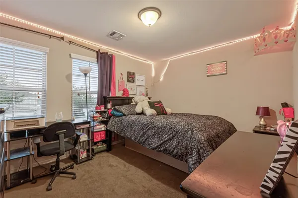 a view of a house with backyard and a tree