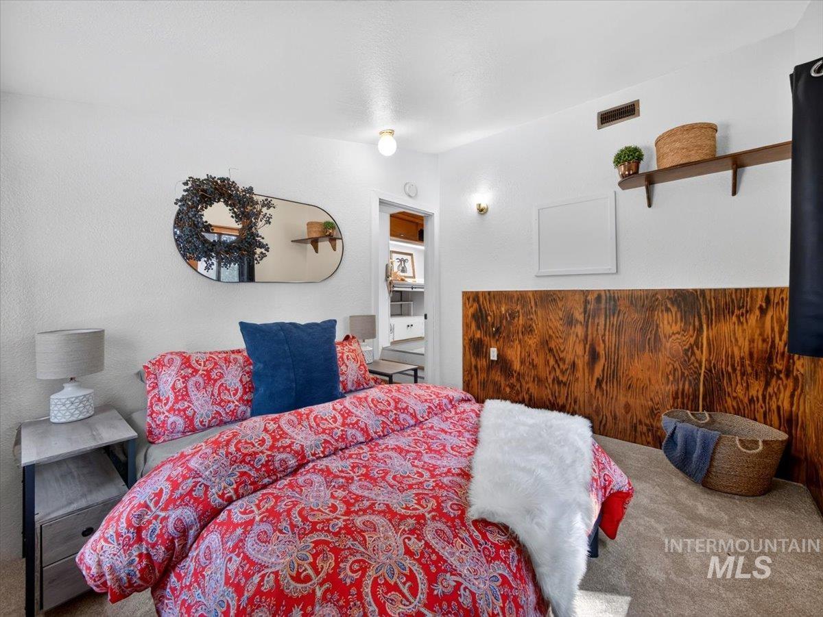 6 Rattlesnake Road Boise City, ID 83716 - Photo 36 of 50 Bedroom featuring textured white walls, wood-finish wainscoting, and carpet flooring