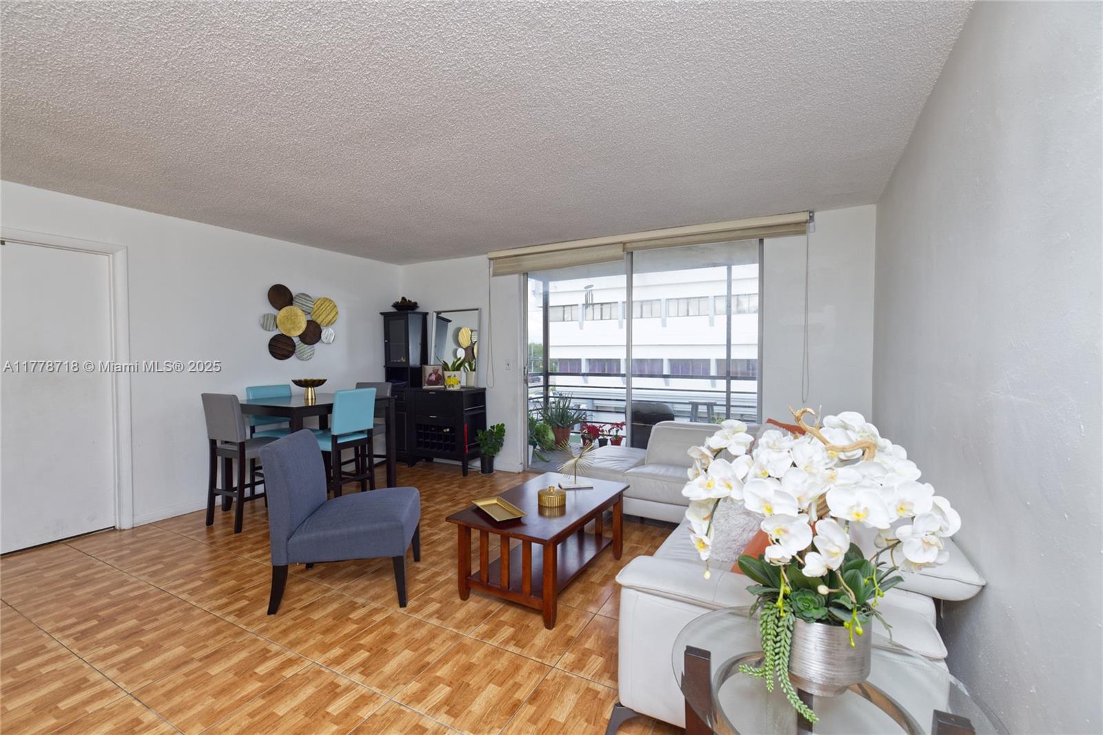 a living room with furniture and flowers