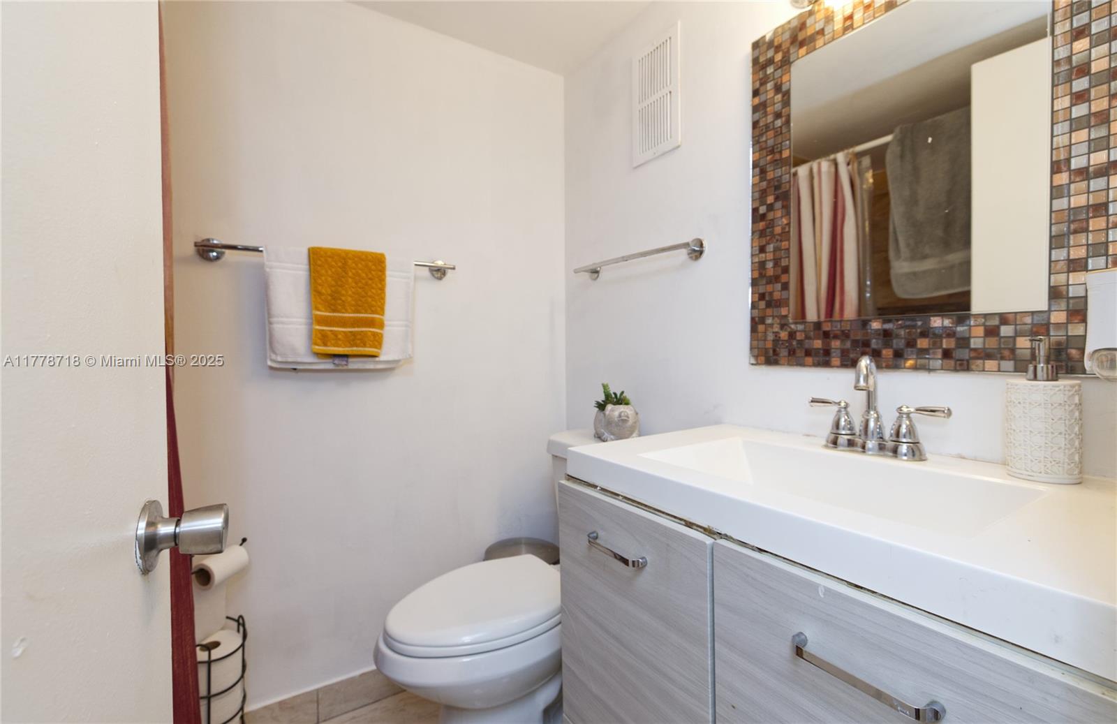 3195 Foxcroft Road, Unit F302 Miramar, FL 33025 - Photo 12 of 28 a bathroom with a toilet sink and mirror