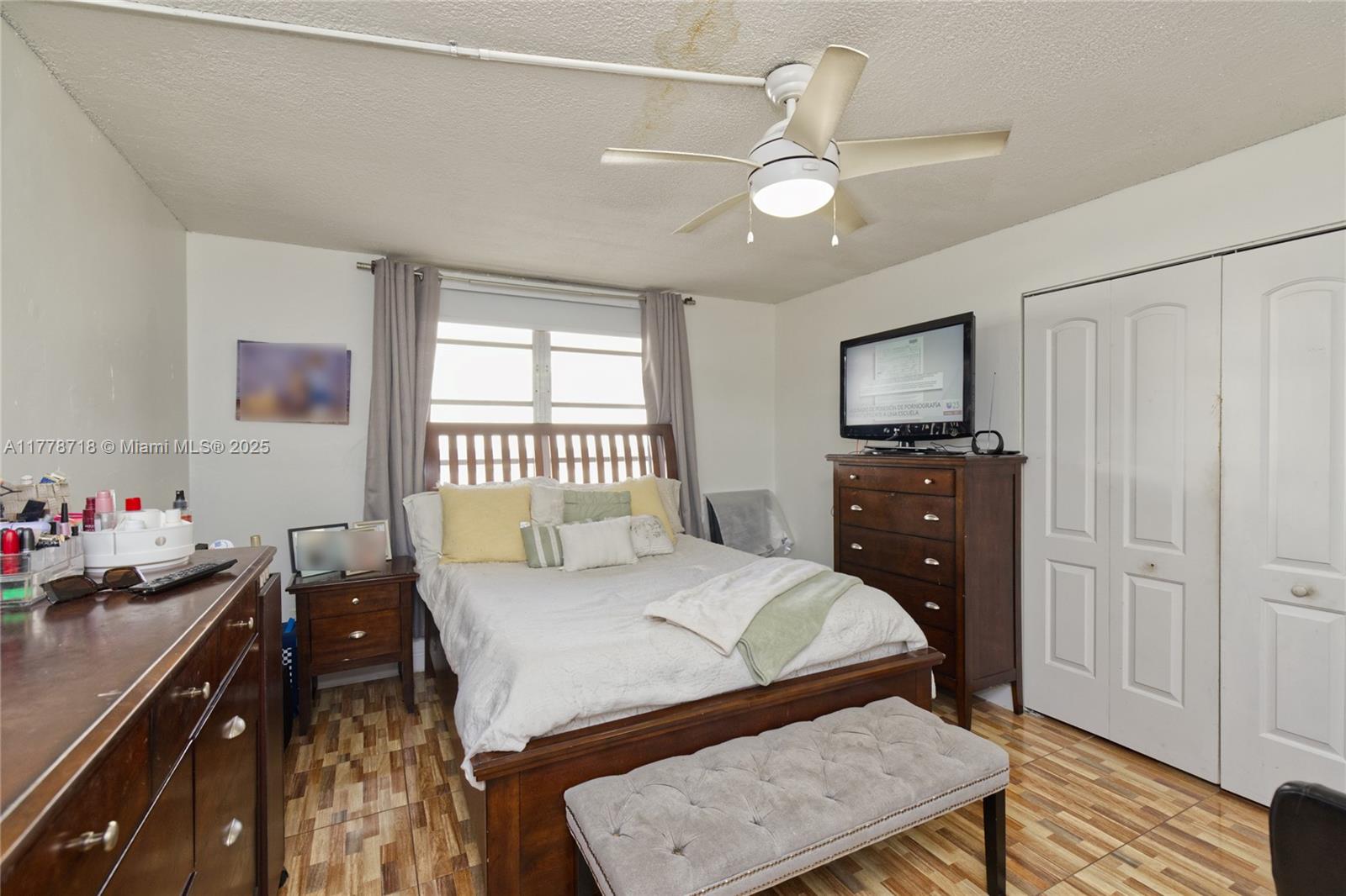 3195 Foxcroft Road, Unit F302 Miramar, FL 33025 - Photo 17 of 28 a bedroom with a bed and wooden floor