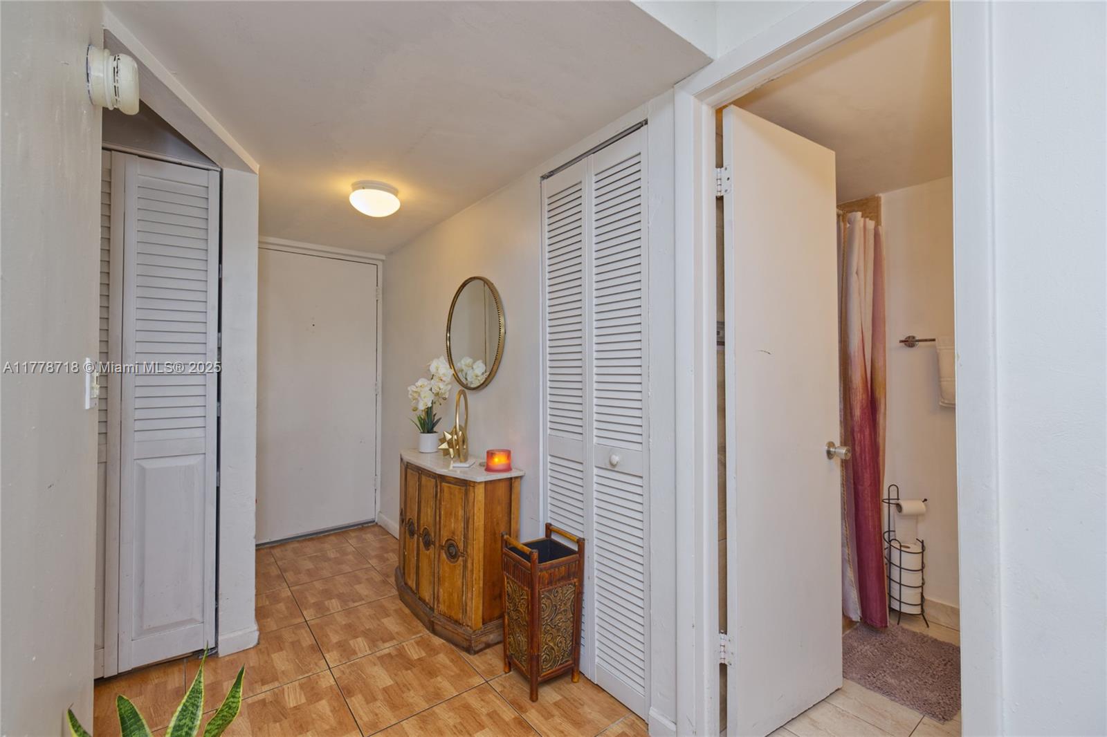 3195 Foxcroft Road, Unit F302 Miramar, FL 33025 - Photo 10 of 28 a view of a hallway and closet with wooden floor