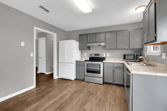 a kitchen with a white cabinets and white appliances