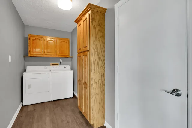 an empty room with a chandelier fan and windows