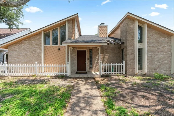 a front view of a house with a fence