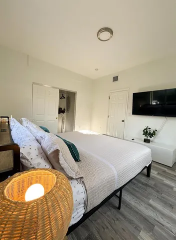a bedroom with a bed and a flat screen tv