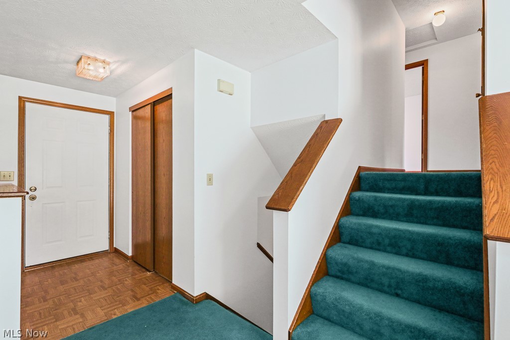 2642 Blake Road Wadsworth, OH 44281 - Photo 10 of 46 Staircase featuring teal carpeting and wood handrails
