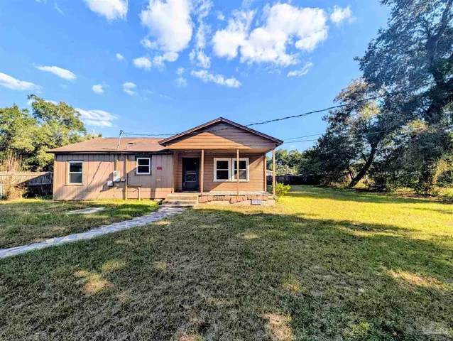 a view of a house with swimming pool and yard