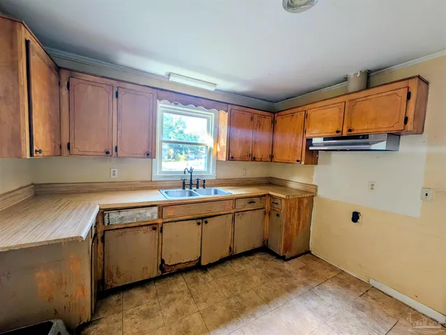 a kitchen that has a sink and a stove