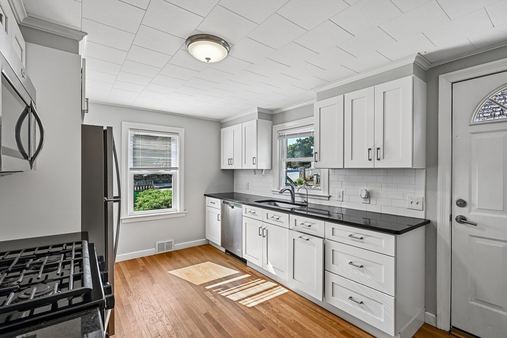42 East Main Street Gloucester, MA 01930 - Photo 7 of 25 a kitchen with a sink stove and cabinets