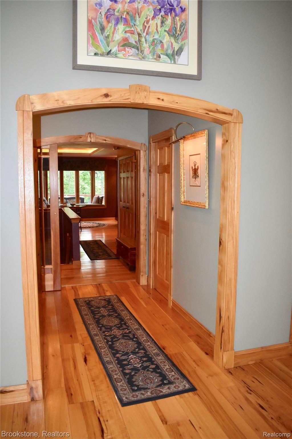 405 Baldwin Ridge Oxford, MI 48371 - Photo 27 of 54 THE HALLWAY FROM THE LARGE GREAT ROOM (19X23) LEADS TO A LARGE OPEN AREA WHICH CONTAINS A FAMILY ROOM, DINING ROOM & "CUSTOM" KITCHEN