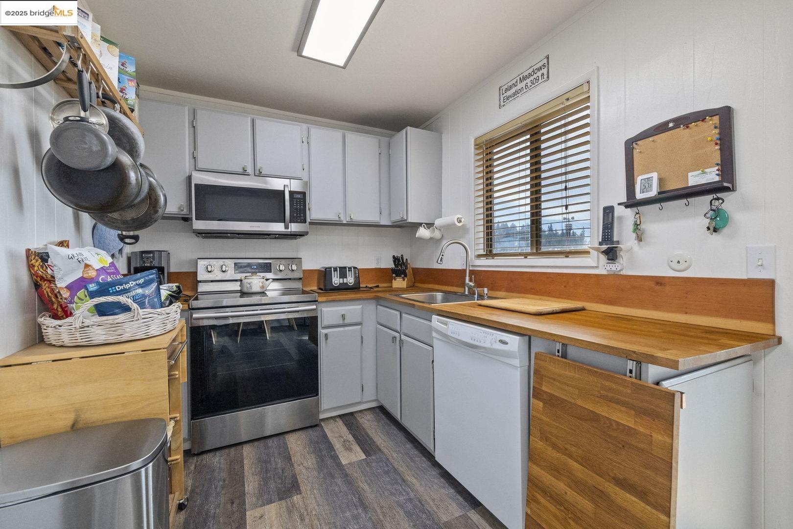 33781 Upper Leland Road, Unit A Pinecrest, CA 95364 - Photo 13 of 33 a kitchen with stainless steel appliances granite countertop a sink dishwasher stove top oven and cabinets with wooden floor