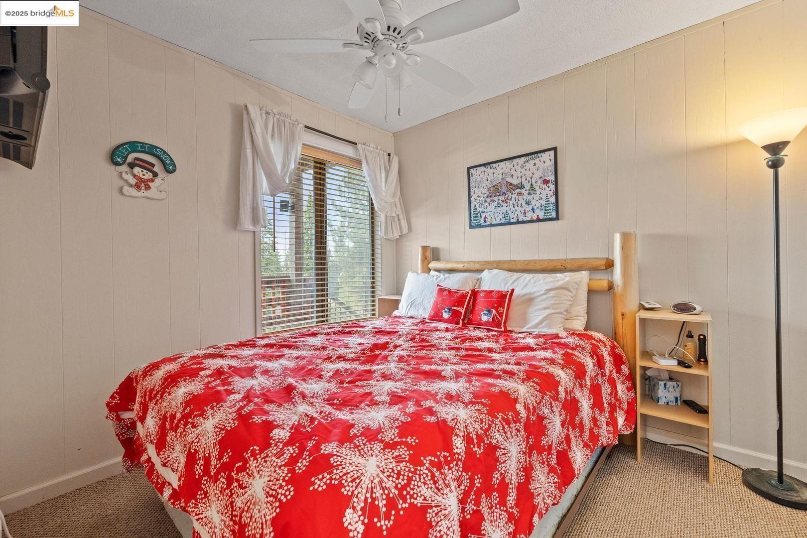 33781 Upper Leland Road, Unit A Pinecrest, CA 95364 - Photo 21 of 33 a bedroom with a large bed and a chandelier