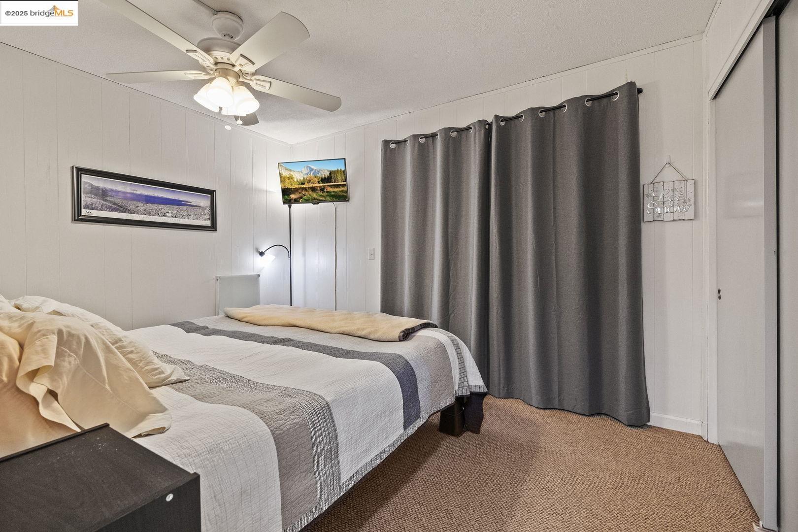 33781 Upper Leland Road, Unit A Pinecrest, CA 95364 - Photo 23 of 33 a bedroom with a large bed and a chandelier