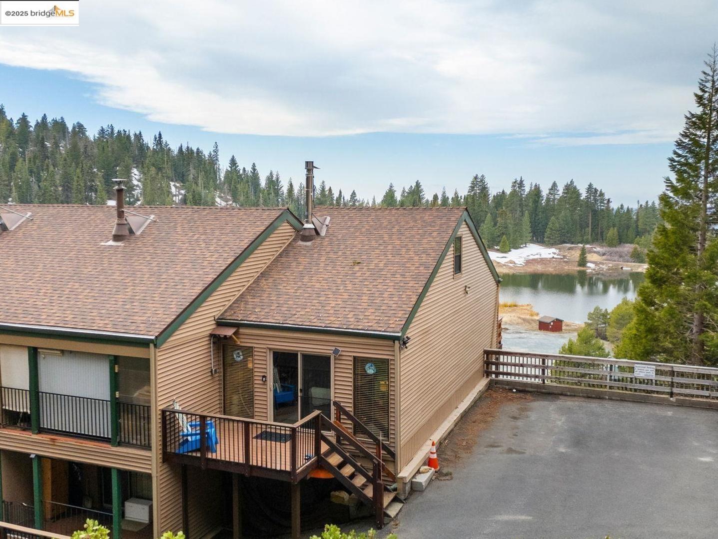 33781 Upper Leland Road, Unit A Pinecrest, CA 95364 - Photo 24 of 33 a view of a house with a balcony and trees in the background