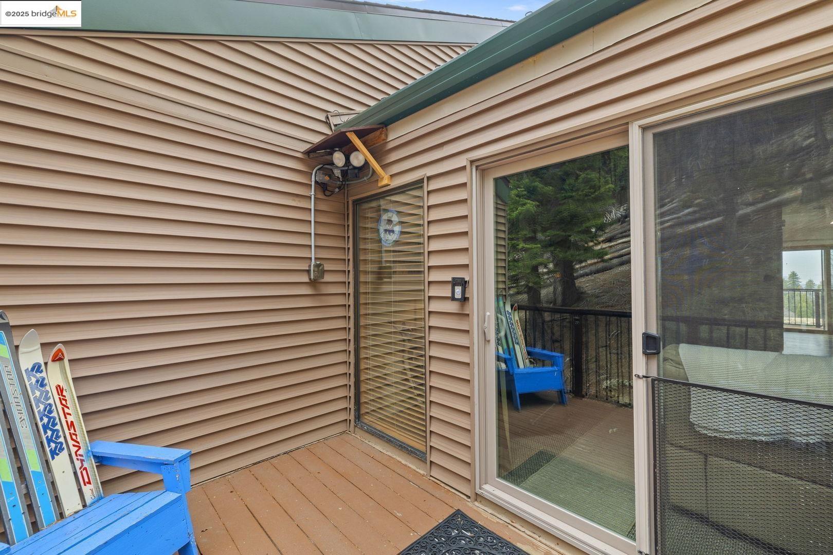 33781 Upper Leland Road, Unit A Pinecrest, CA 95364 - Photo 32 of 33 a view of a balcony with floor to ceiling windows with wooden floor