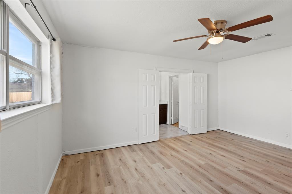 1012 East Dallas Street Mansfield, TX 76063 - Photo 13 of 25 a view of an empty room with wooden floor and a window