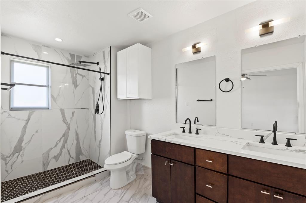 1012 East Dallas Street Mansfield, TX 76063 - Photo 14 of 25 a bathroom with a double vanity sink toilet and shower