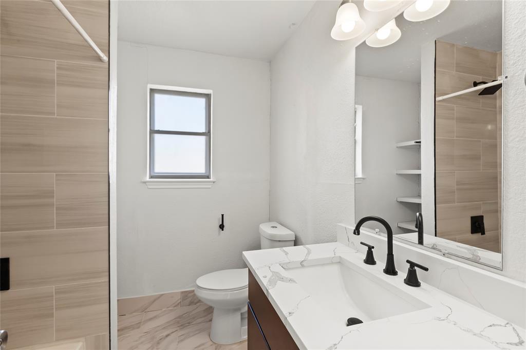 1012 East Dallas Street Mansfield, TX 76063 - Photo 21 of 25 a bathroom with a sink a toilet and shower