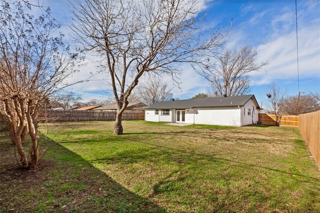 1012 East Dallas Street Mansfield, TX 76063 - Photo 24 of 25 a white house with a big yard and large trees
