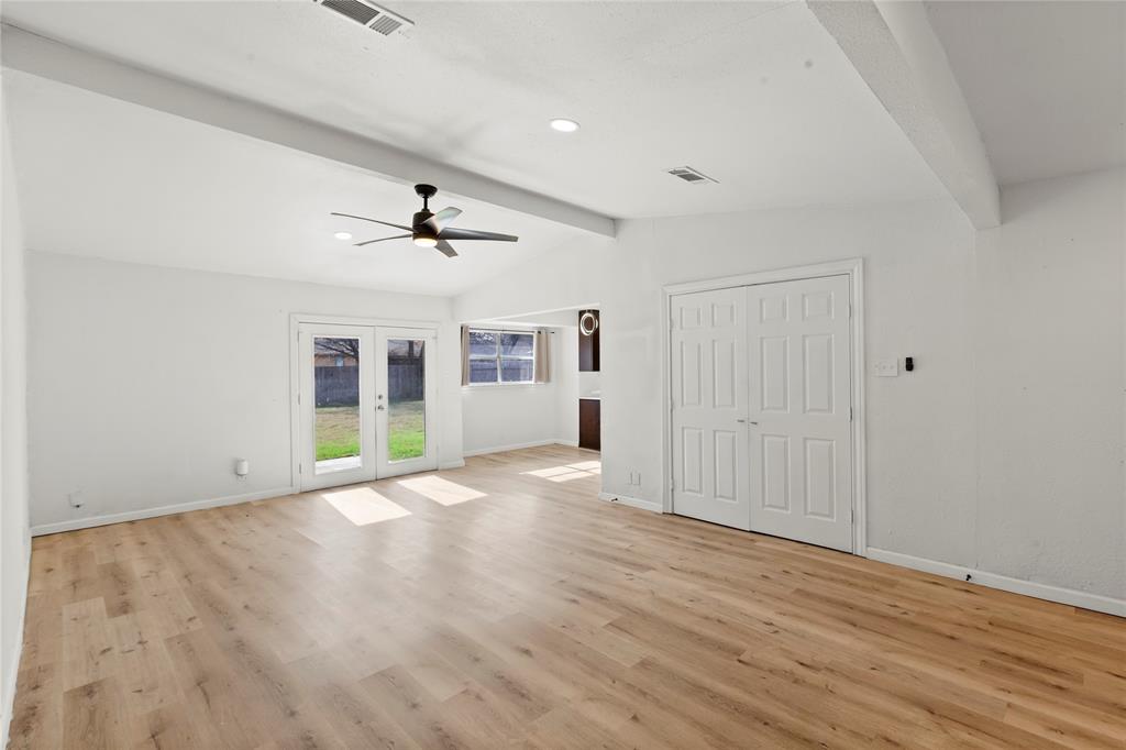 1012 East Dallas Street Mansfield, TX 76063 - Photo 6 of 25 a view of an empty room with wooden floor and a window
