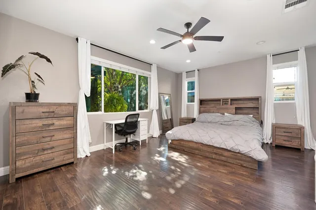 a bedroom with a bed a table and chair