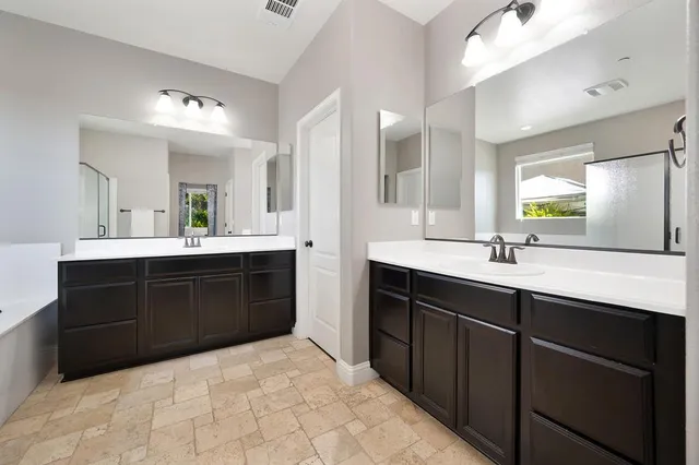 a spacious bathroom with a sink double vanity and a mirror