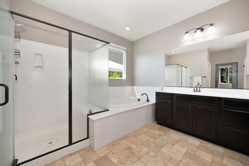 806 Mono Street Manteca, CA 95337 - Photo 17 of 38 a spacious bathroom with a tub sink and mirror
