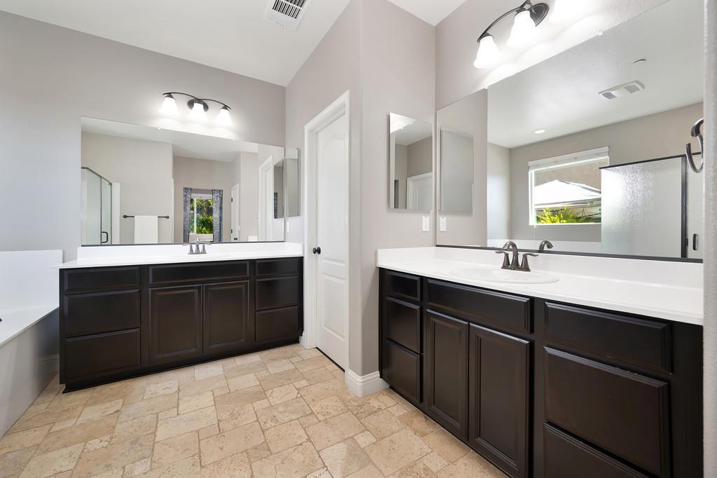 806 Mono Street Manteca, CA 95337 - Photo 18 of 38 a spacious bathroom with a sink double vanity and a mirror