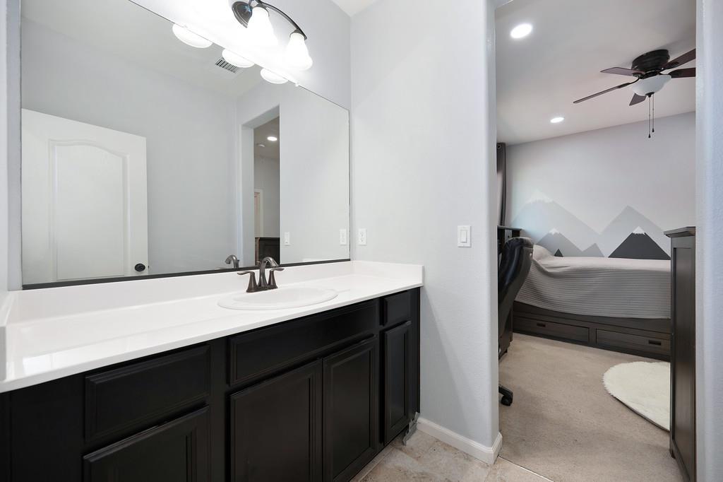 806 Mono Street Manteca, CA 95337 - Photo 24 of 38 a en suite bathroom with a double vanity sink and a mirror
