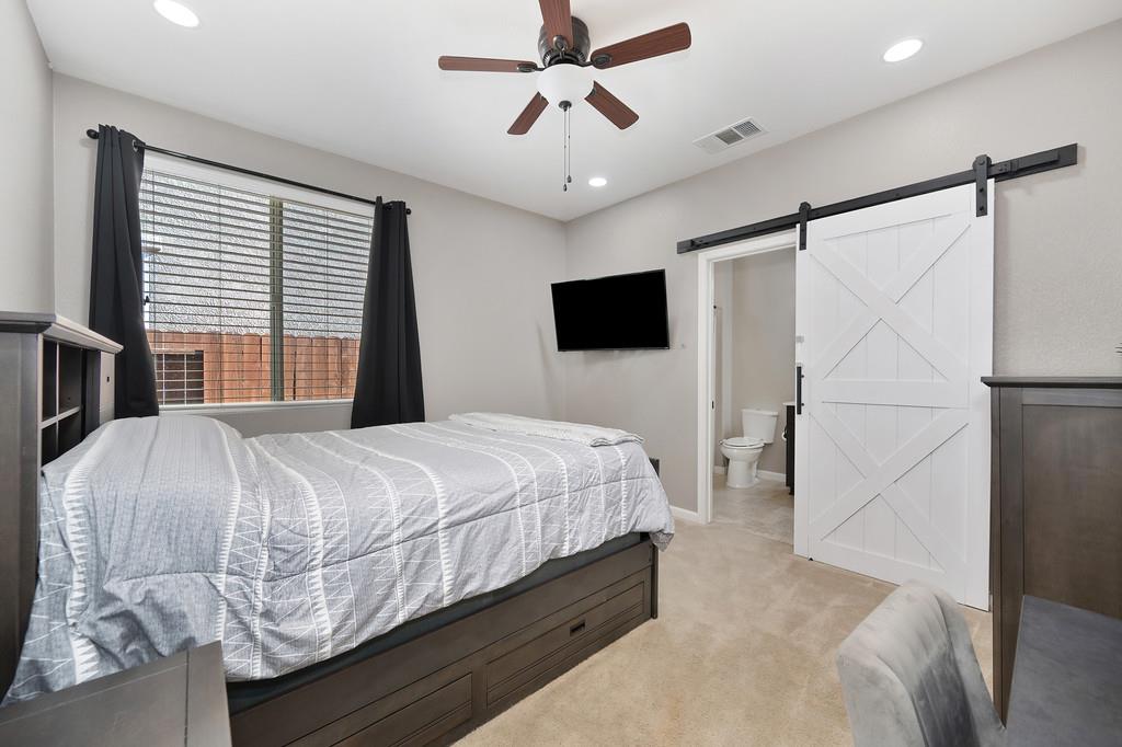 806 Mono Street Manteca, CA 95337 - Photo 26 of 38 a bedroom with a bed and a chandelier